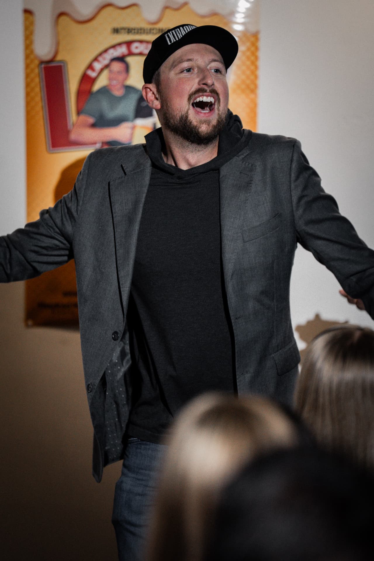 Host firing up the room in front of the LOL Beer banner