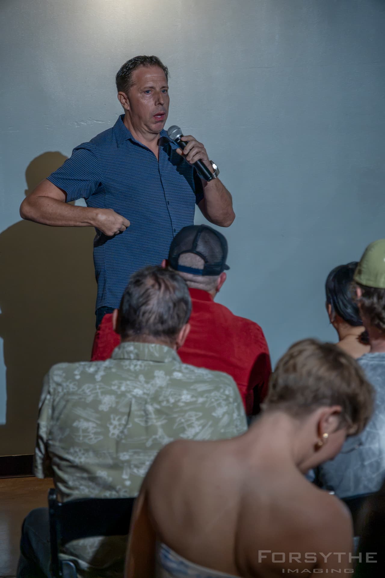 Comedian delivering a bit over the crowd